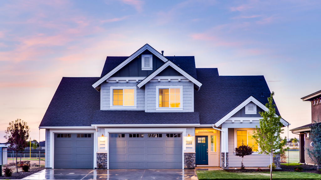 A large white house with a blue roof and a blue garage door.