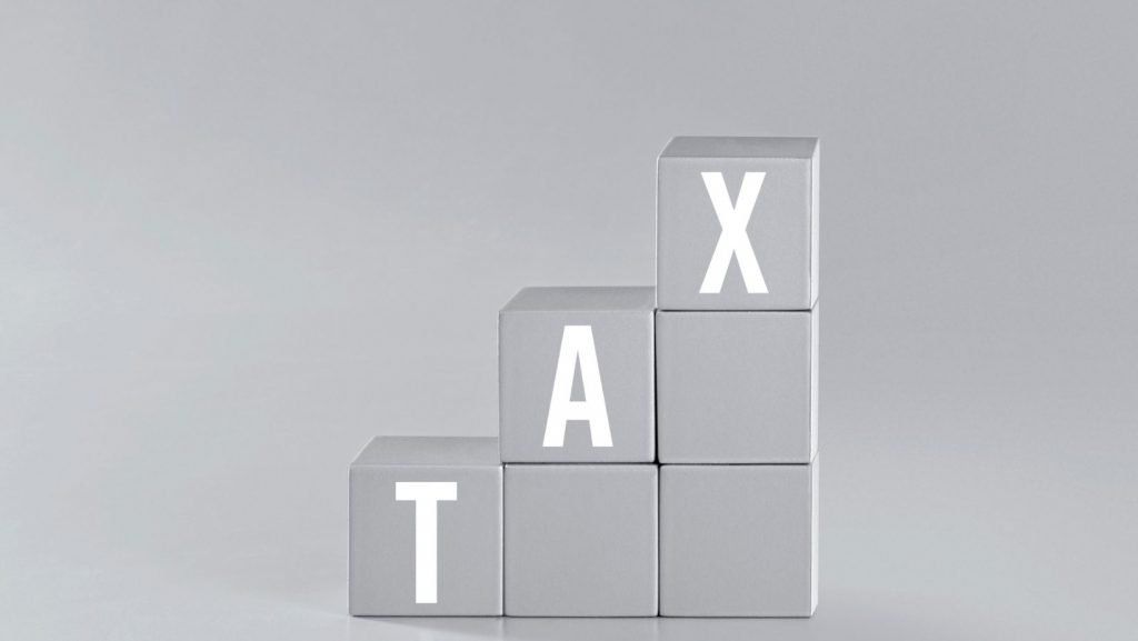 A stack of blocks with the word tax written on them.