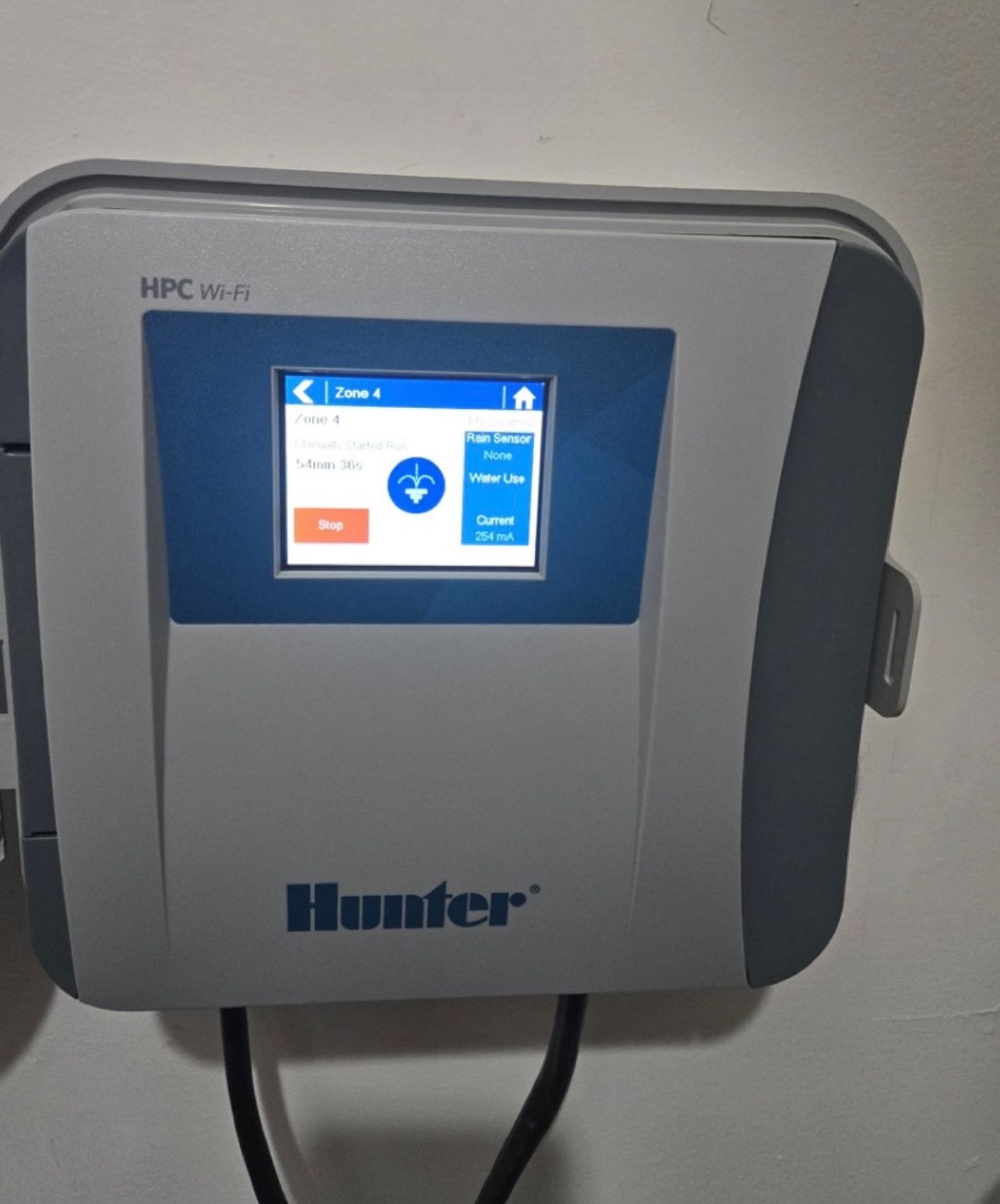 A hunter device is hanging on a white wall