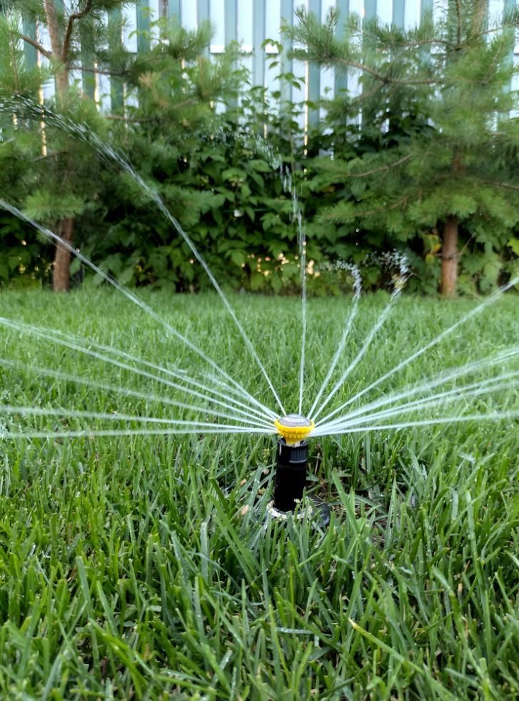 Sprinkler Irrigation Water on Green Grass in a Yard — iWater NT Pty Ltd in Yarrawonga, NT