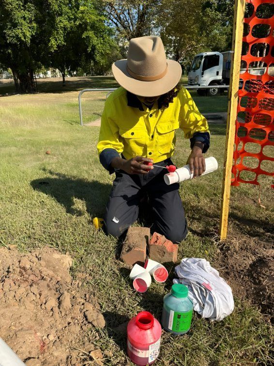 Person Working With Pipes, Tools, and Colored Liquids — iWater NT Pty Ltd in Yarrawonga, NT