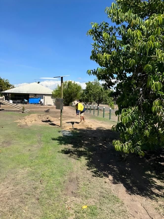 Person With Yellow Shirt Digging a Hole in Sunny Day — iWater NT Pty Ltd in Yarrawonga, NT