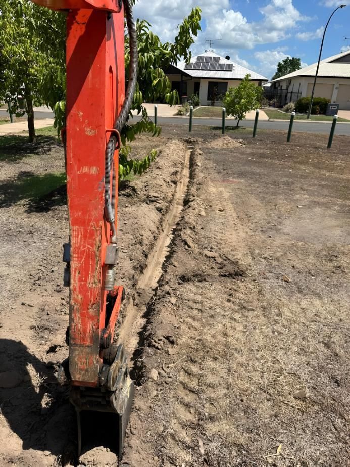 Orange Excavator Digging a Narrow Trench — iWater NT Pty Ltd in Yarrawonga, NT