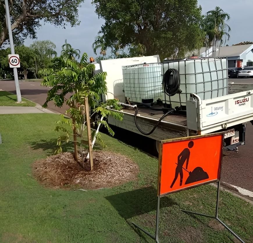 Truck With Water Tanks Watering a Newly Planted Tree — iWater NT Pty Ltd in Yarrawonga, NT