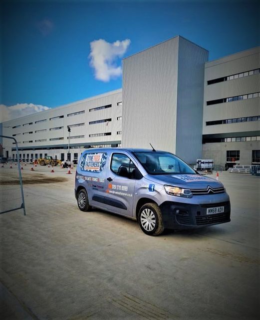 farmland with factories in the background