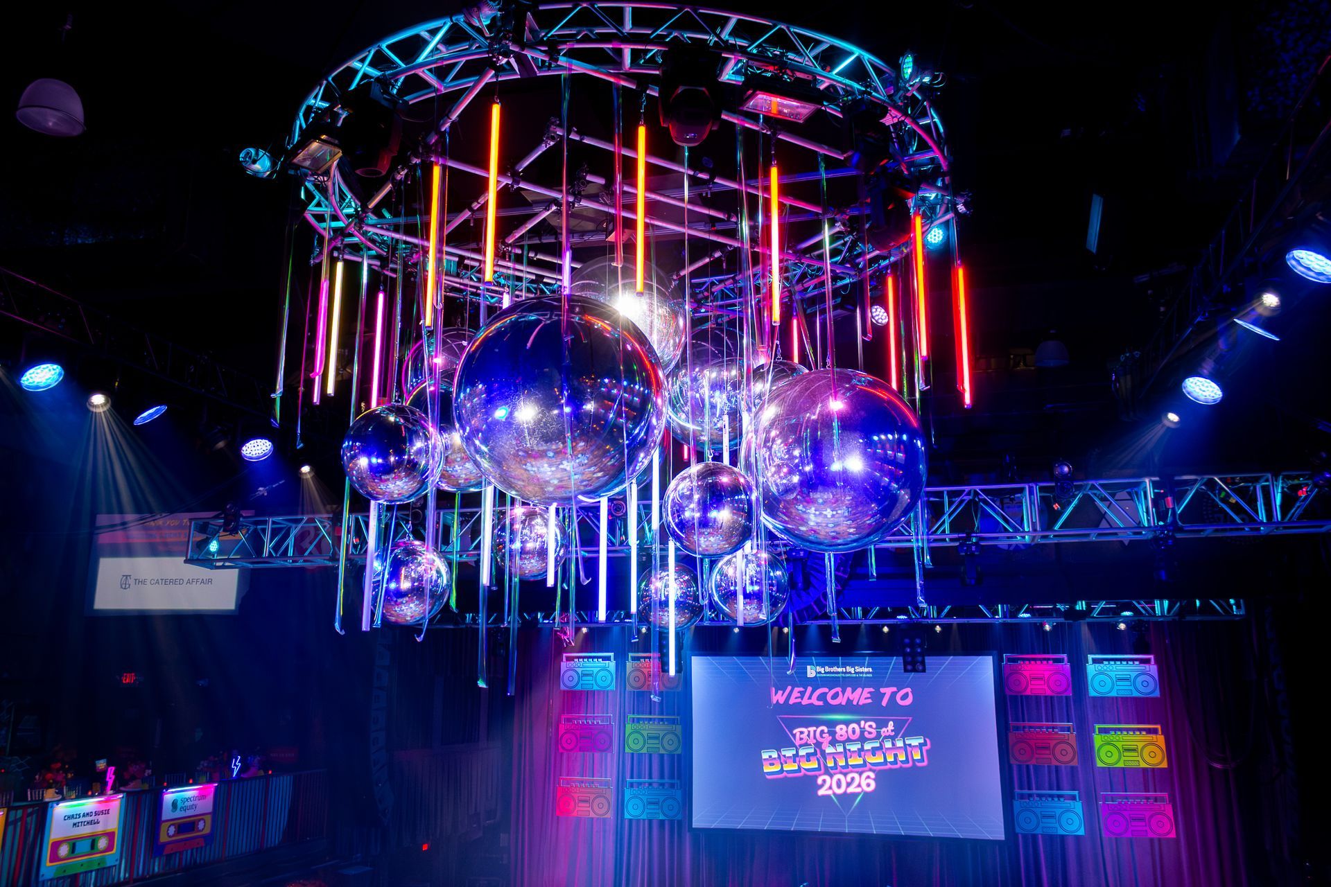 Disco balls and colorful lights at an event.