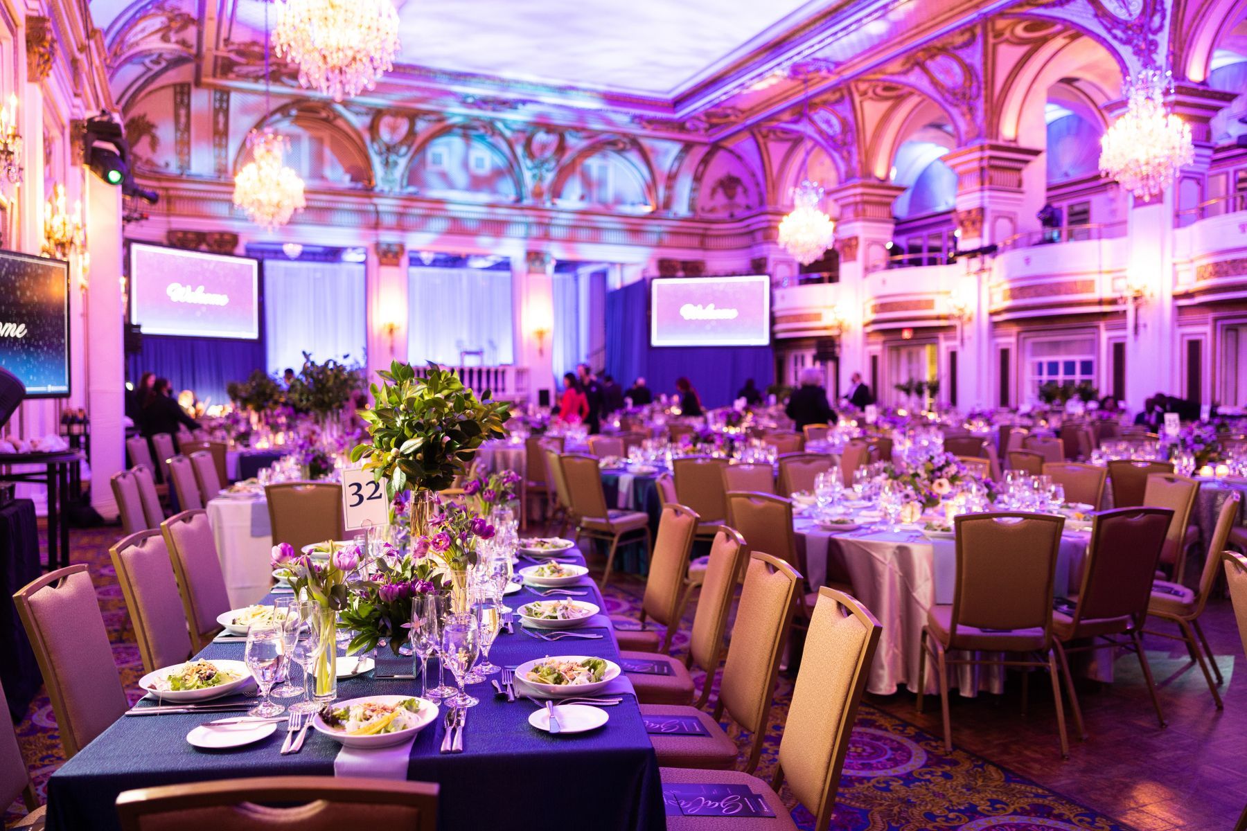 A large room with tables and chairs set up for a banquet.