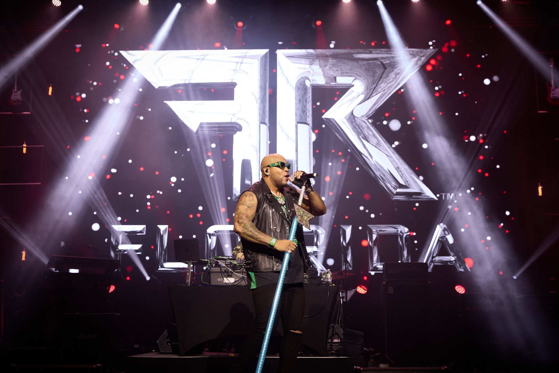 A man is singing into a microphone on a stage.