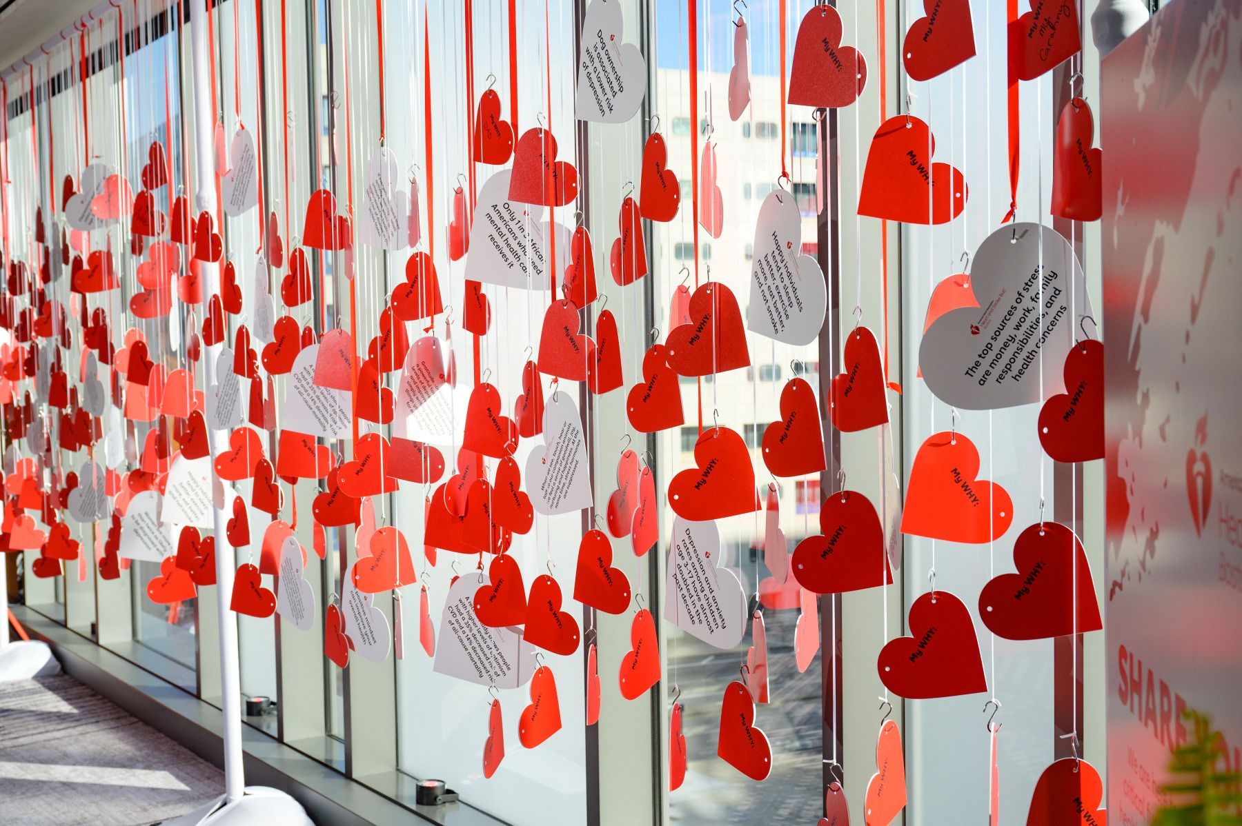 A bunch of red and white hearts hanging from a string.