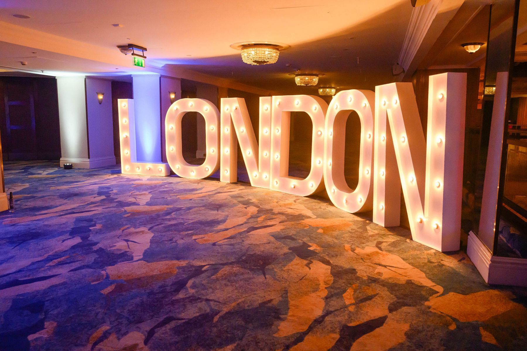 A large sign that says london is lit up in a room.
