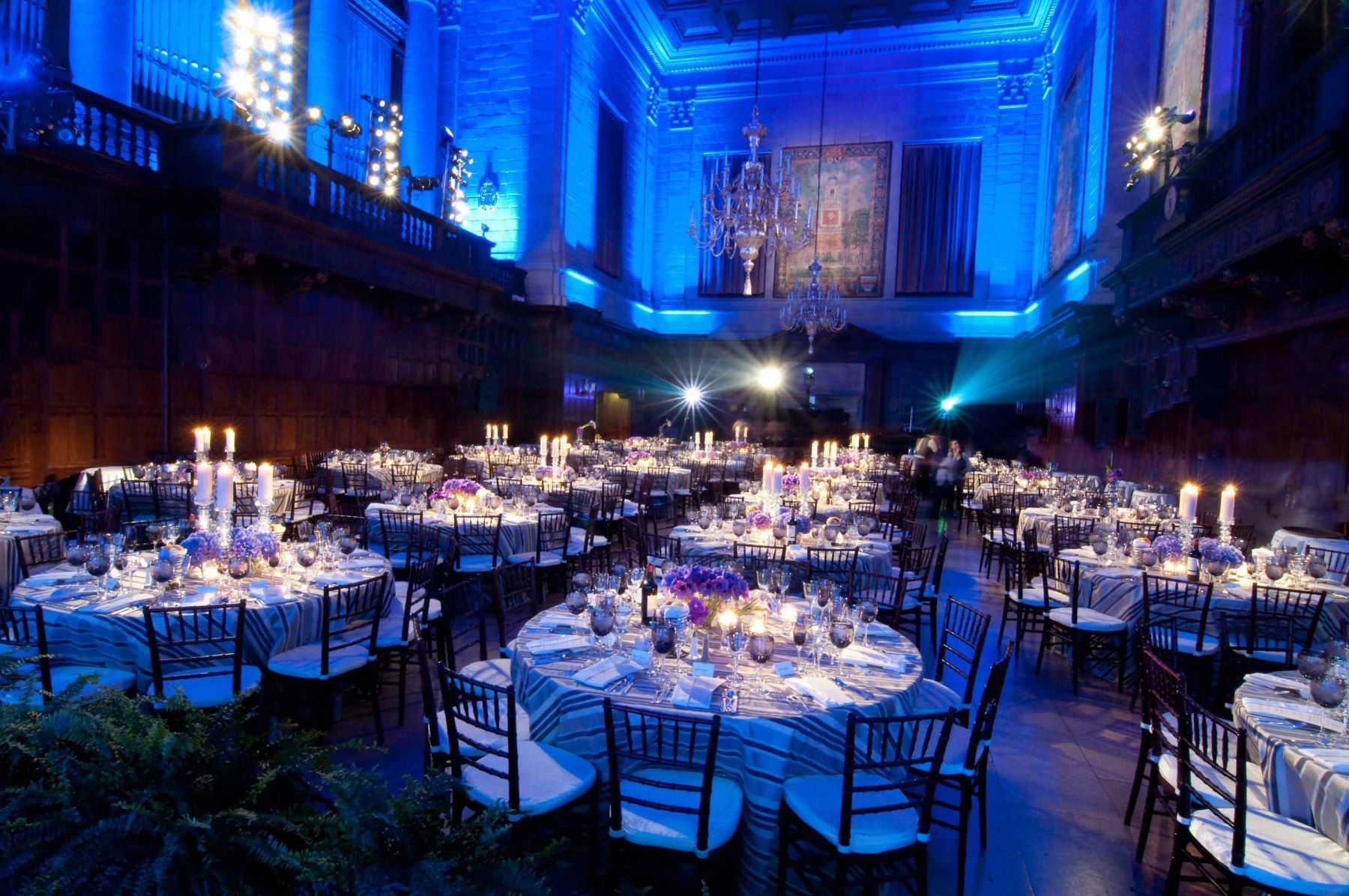 A large room with tables and chairs set up for a party.