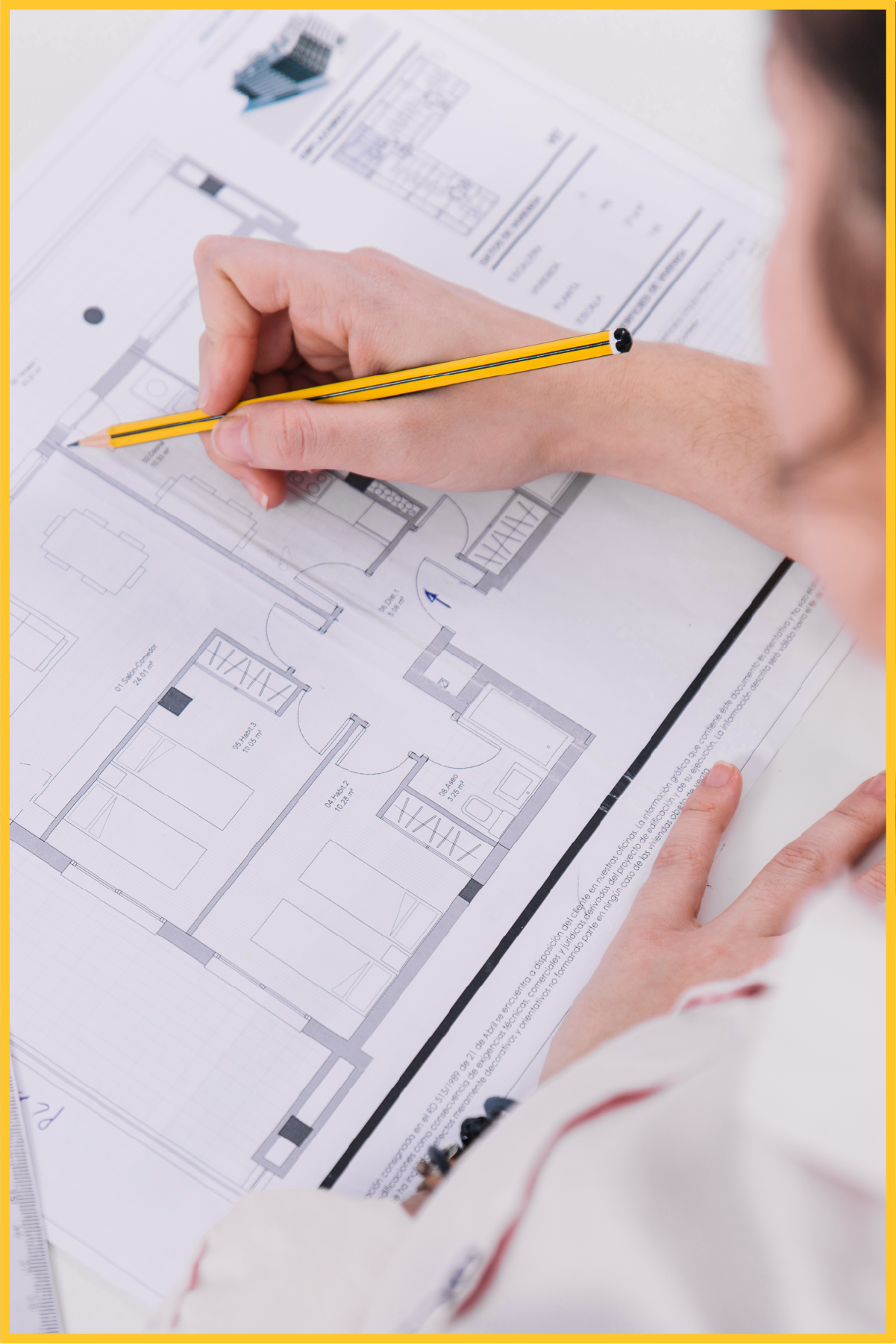 A person is drawing a floor plan with a pencil.