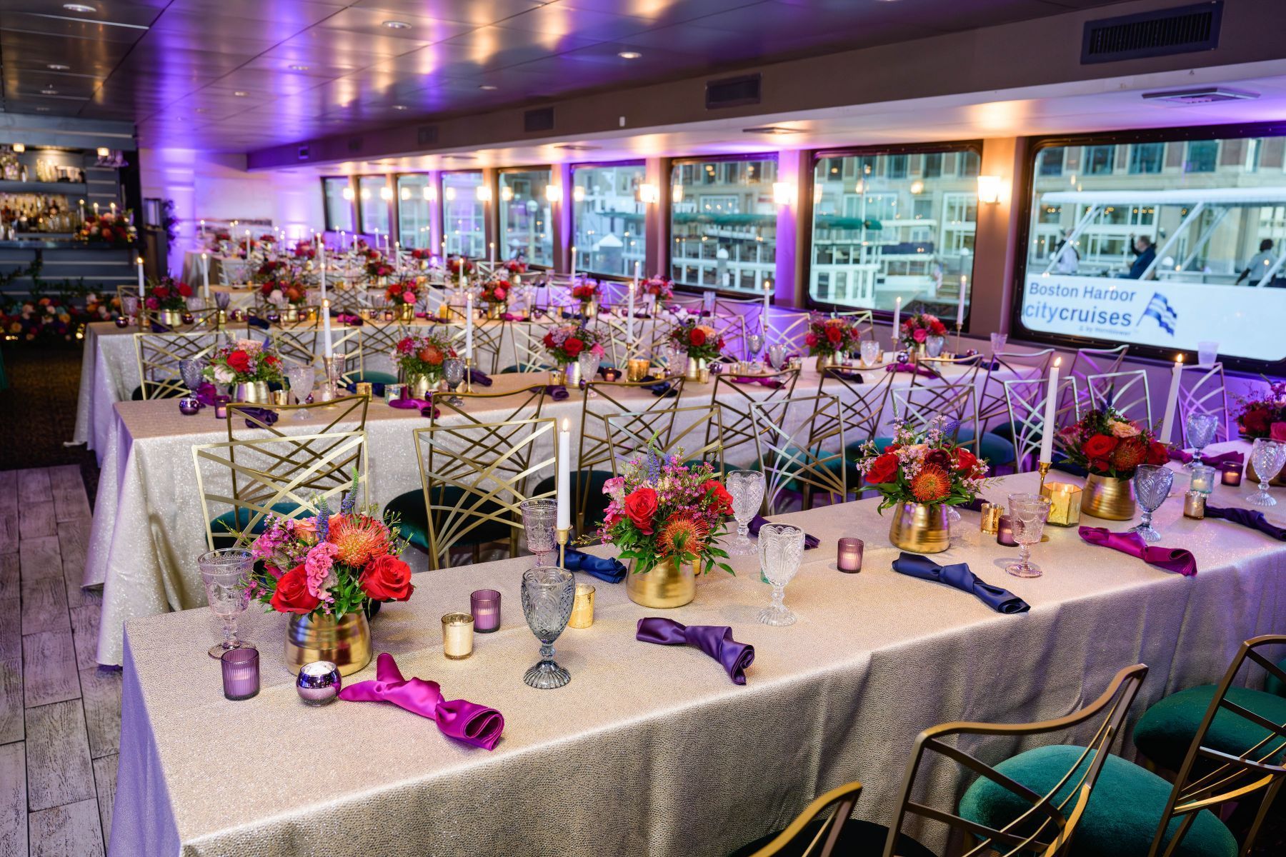 A large room with tables and chairs set up for a wedding reception.