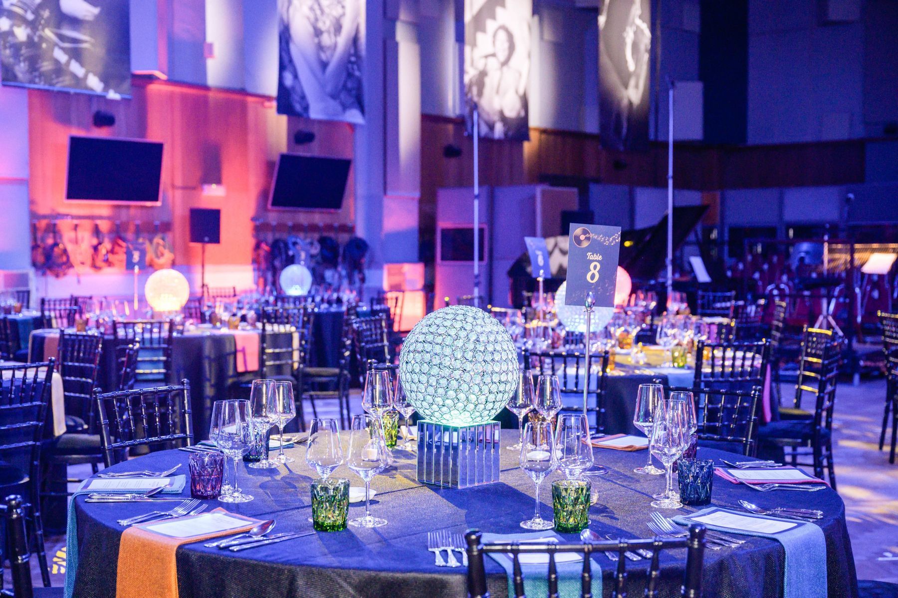 A large room with tables and chairs set up for a party.