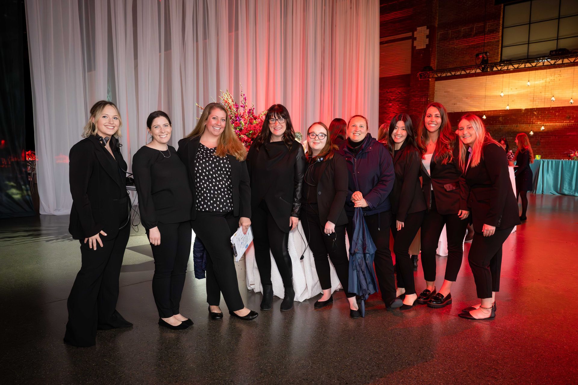 A group of women are posing for a picture in a room.