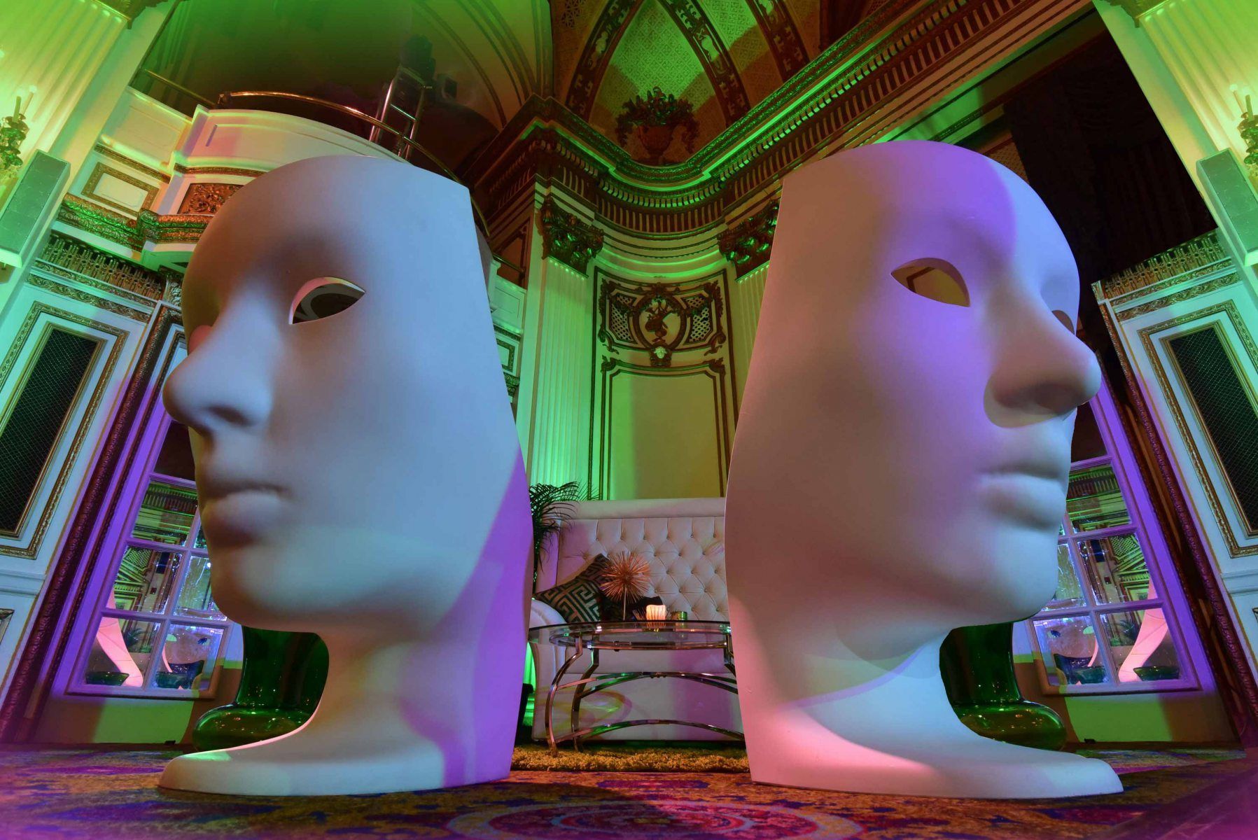 Two white masks are sitting next to each other in a room.
