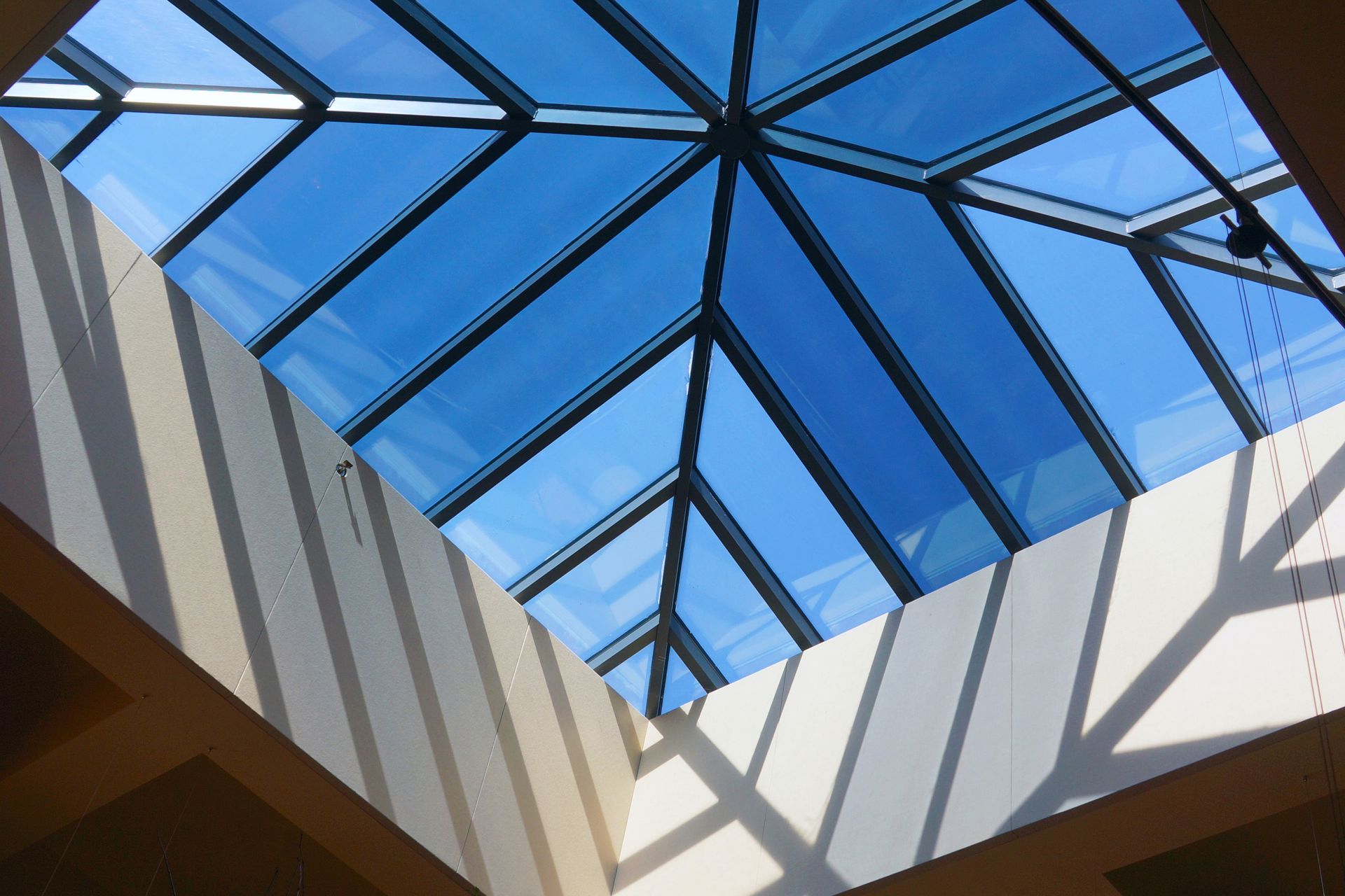 Looking up at the sky through a glass roof.