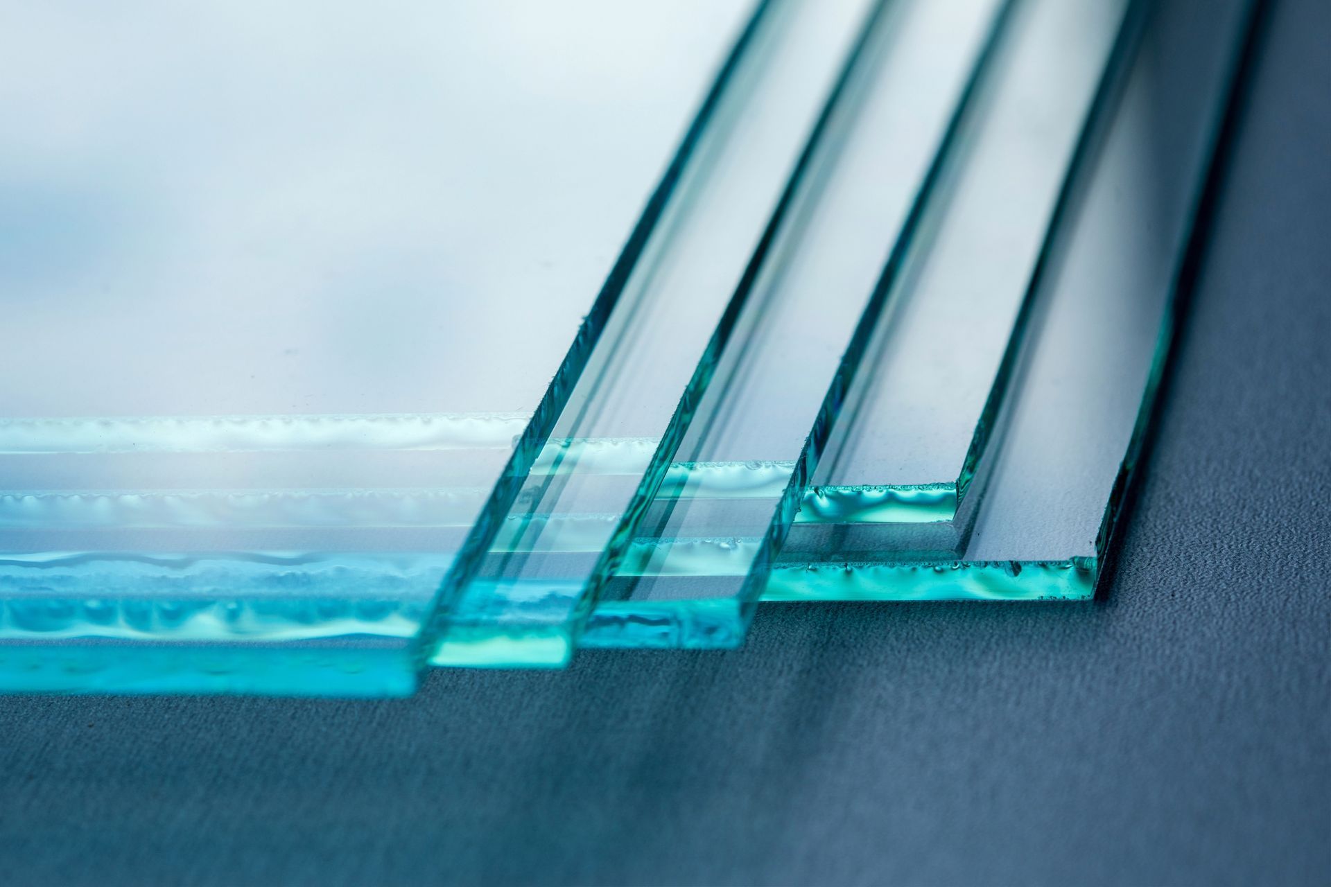 Glass panes stacked on top of each other on a table.