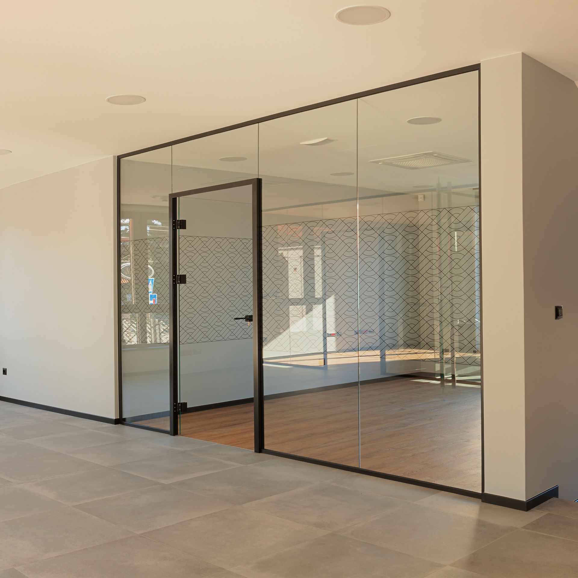 An empty room with a glass wall and door.