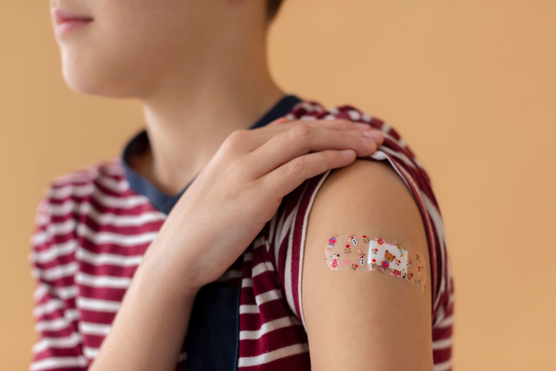 Boy with a bandaid on his arm