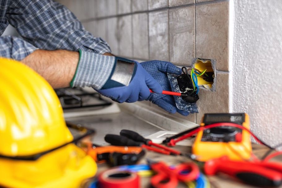 Electrician wiring a junction box.