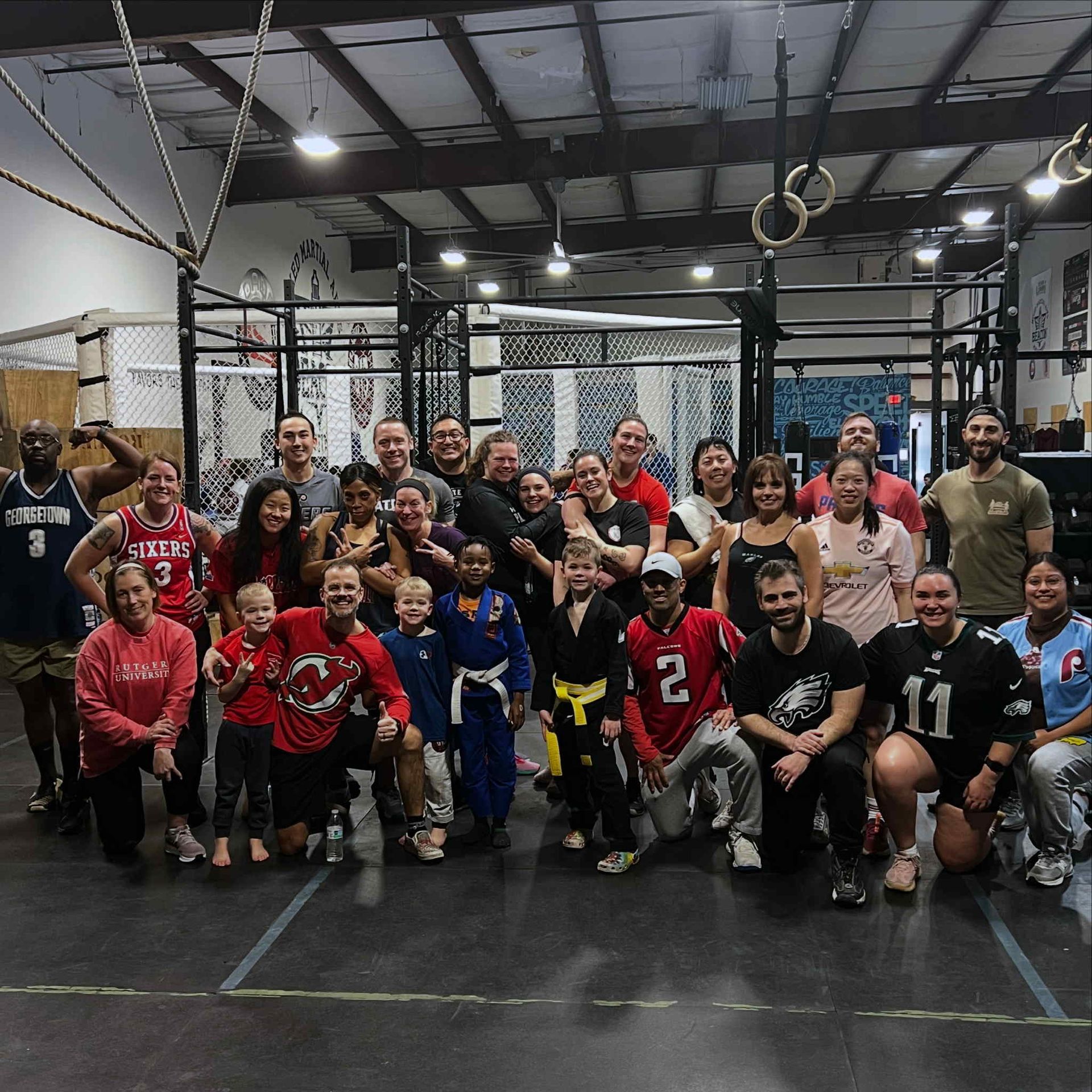 A group of people posing for a picture in a gym