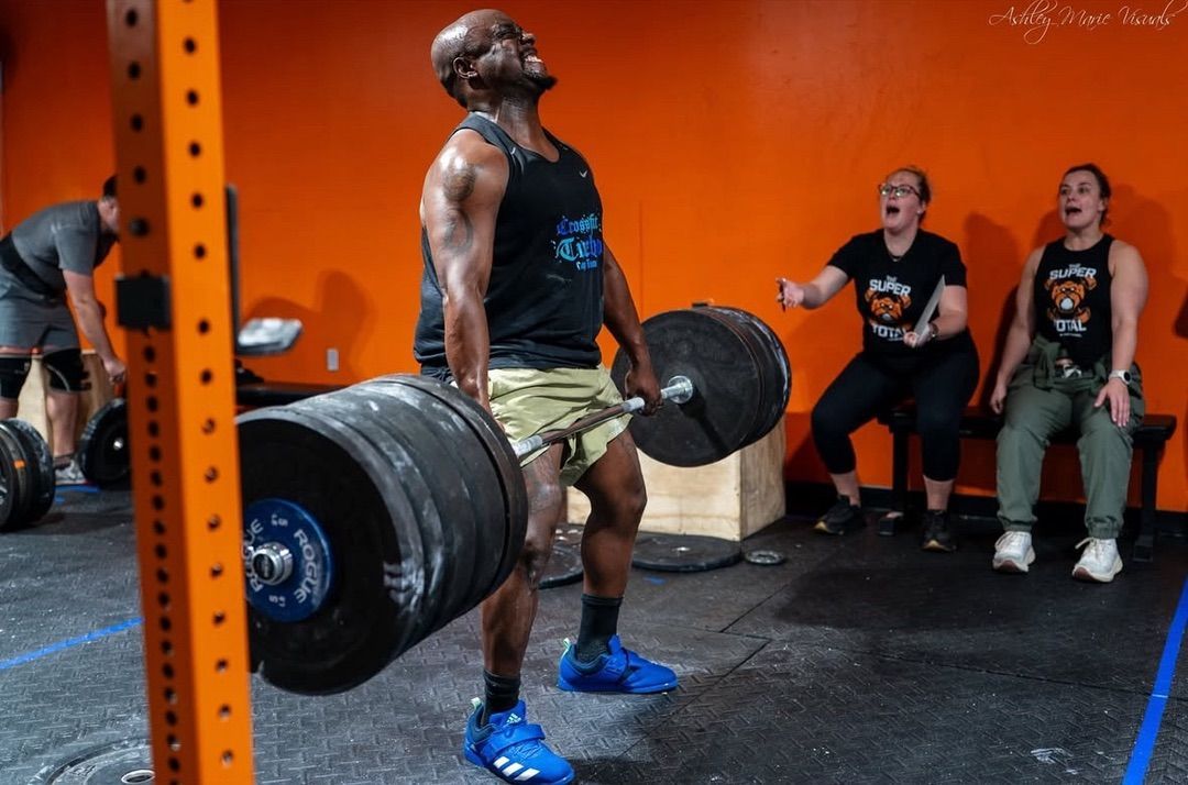 two women lifting barbells over their heads at CrossFit Turbocharged gym in Cherry Hill, NJ