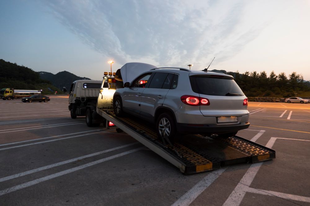 A Car Is Being Towed by A Tow Truck — Mahers Smash Repairs in Nemingha, NSW