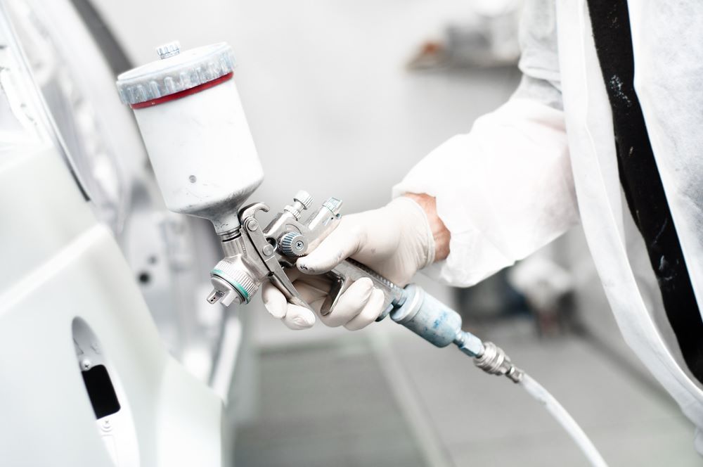 A Man Is Spraying the Car — Mahers Smash Repairs in Kootingal, NSW