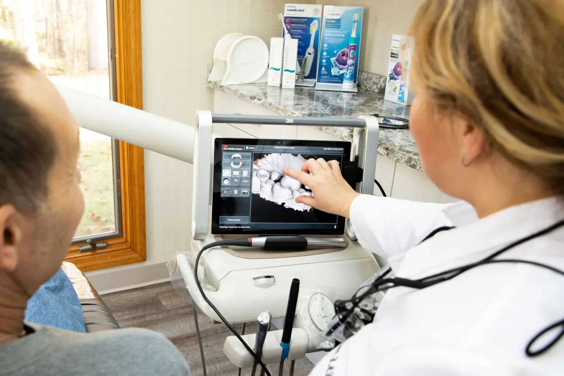 dentist going over xray with patient