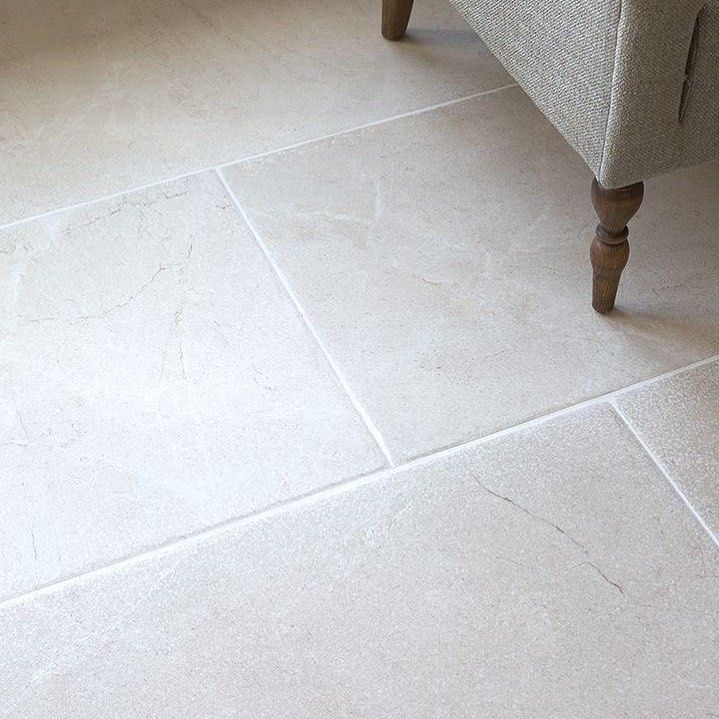 Light stone flooring with a neutral-toned upholstered chair leg in the upper right corner.