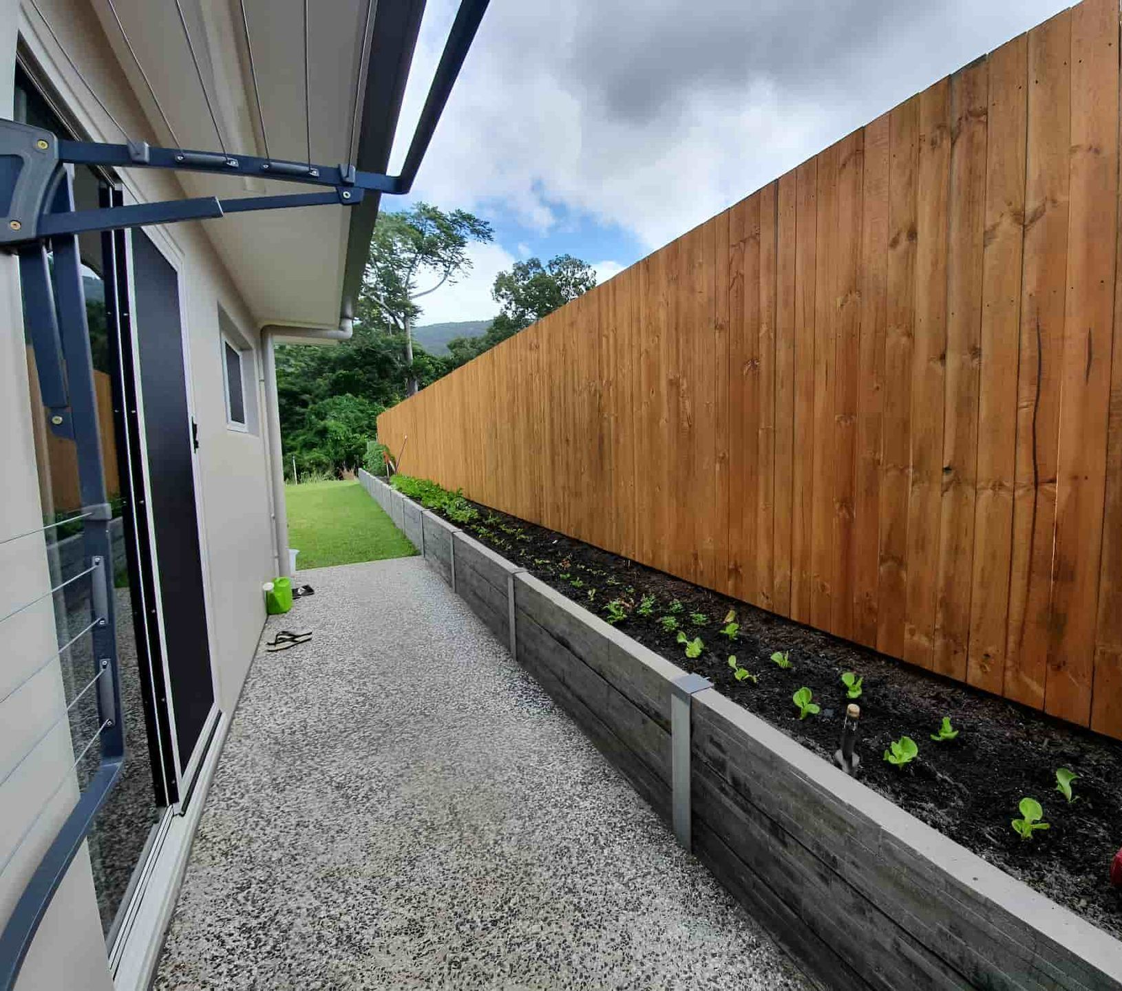 A Wooden Fence And A Concrete Sleepers — NQ Prefab Concrete Products Pty Ltd In Coconuts, QLD