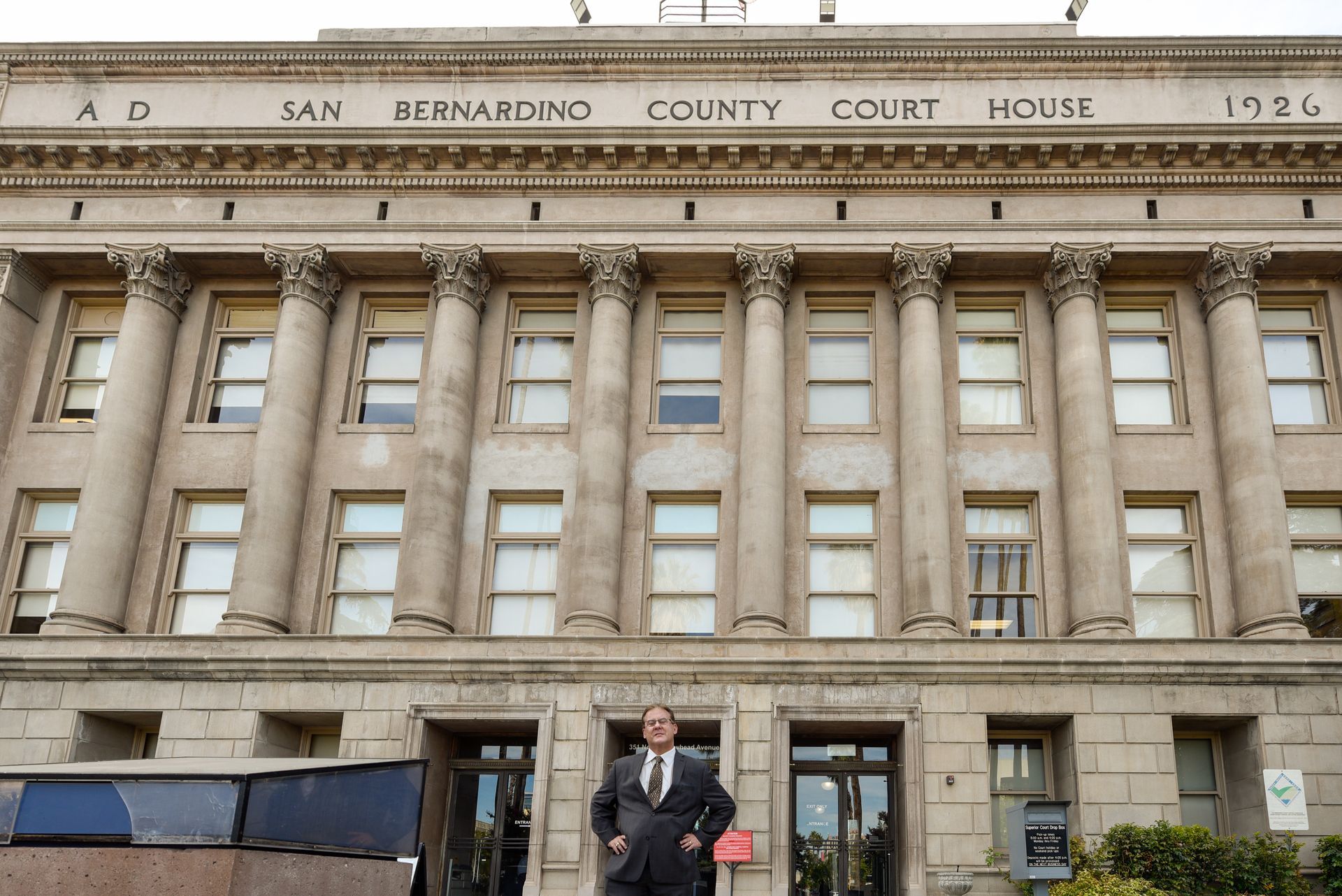 Attorney Greg Kassel standing in front of the old San Bernardino Court House