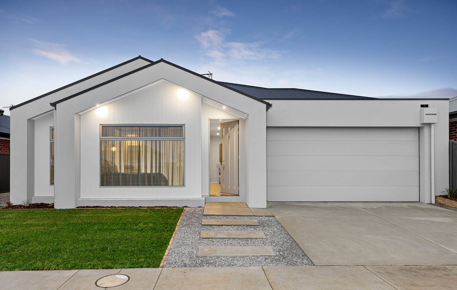 Modern White House With a Garage, Front Door, and Green Lawn — Jetsonian Constructions In Wendouree,