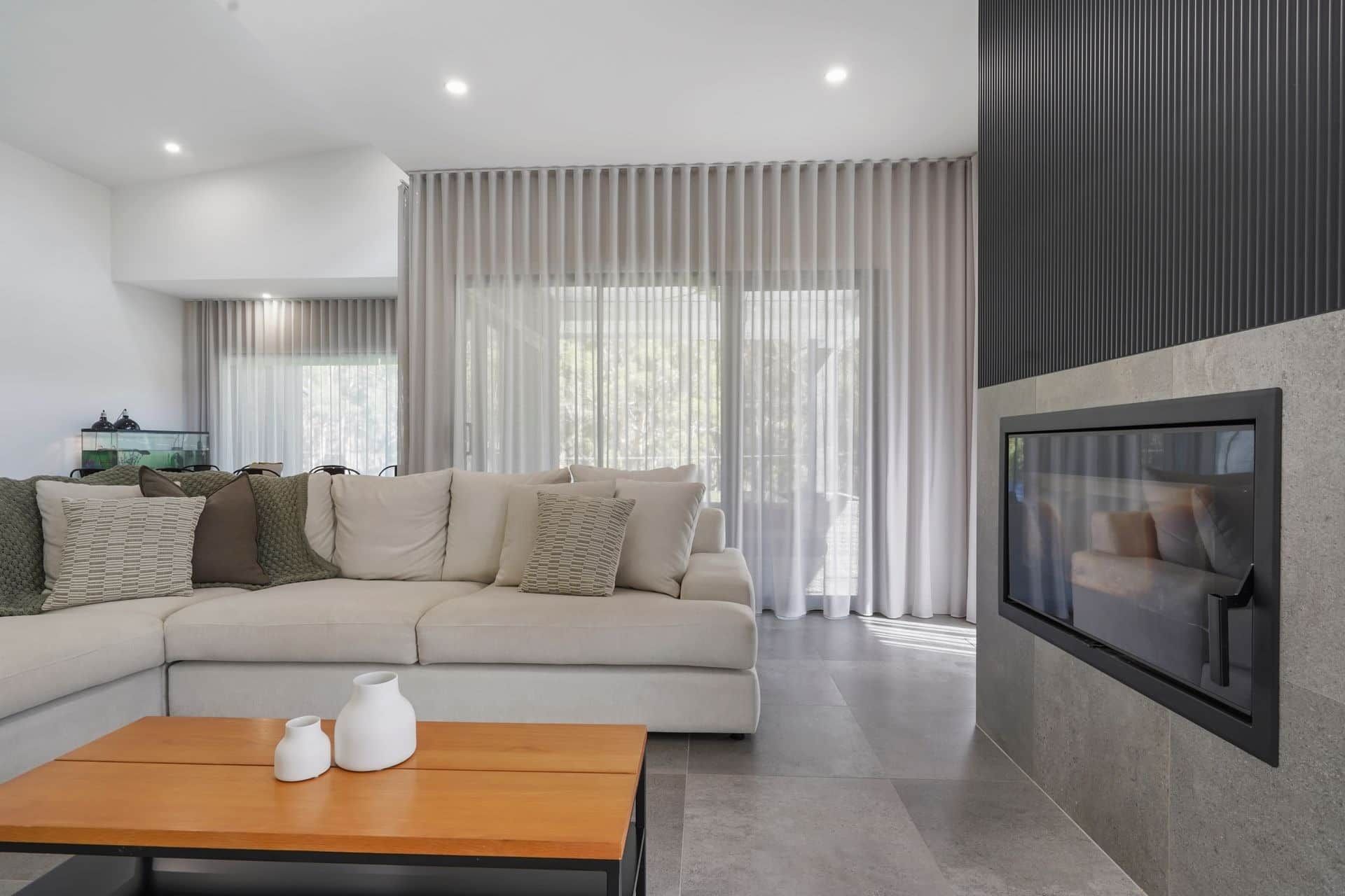 A Living Room With a Couch, Coffee Table and Fireplace — Jetsonian Constructions In Wendouree, VIC