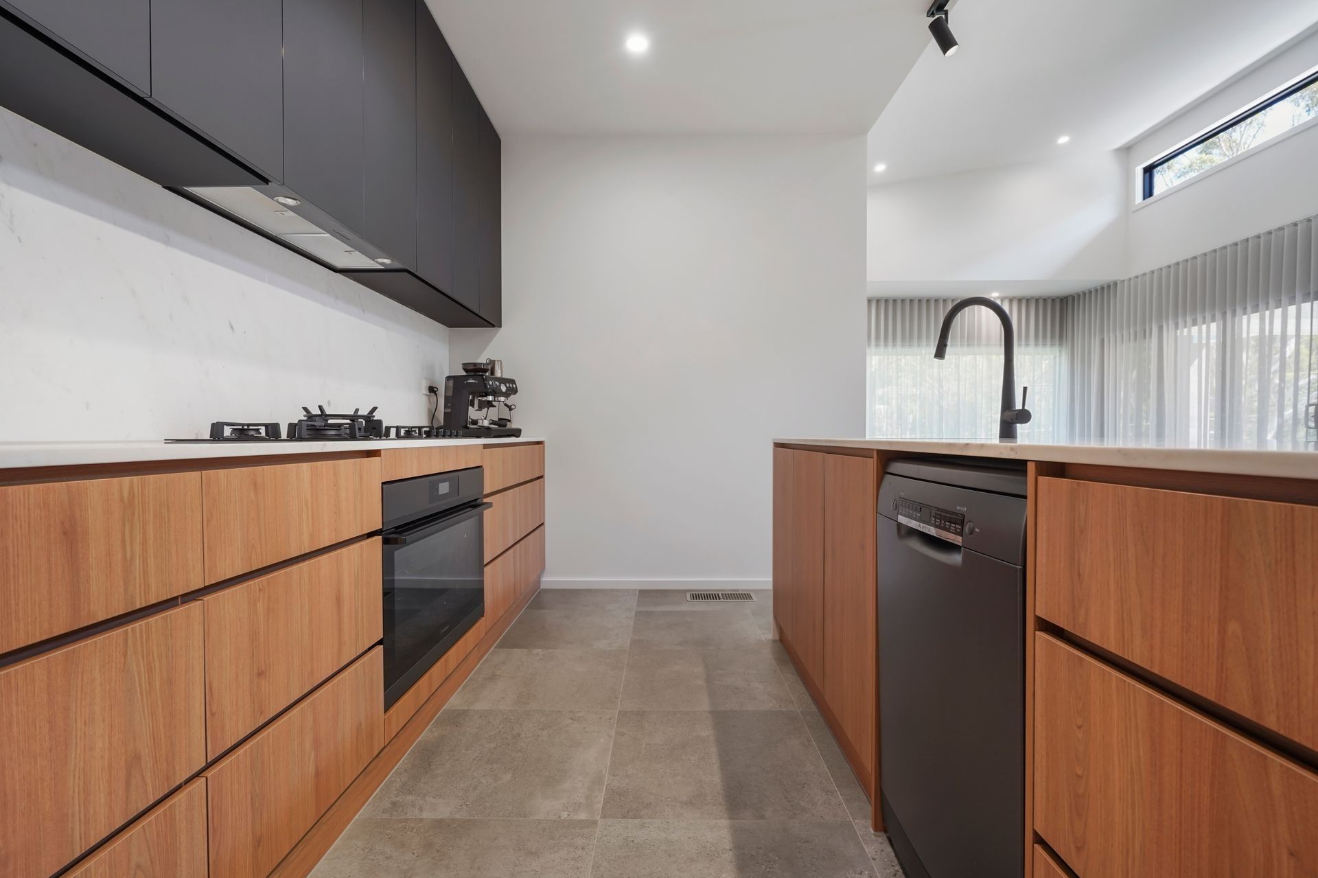 A Kitchen With Wooden Cabinets and a Black Dishwasher — Jetsonian Constructions In Wendouree, VIC