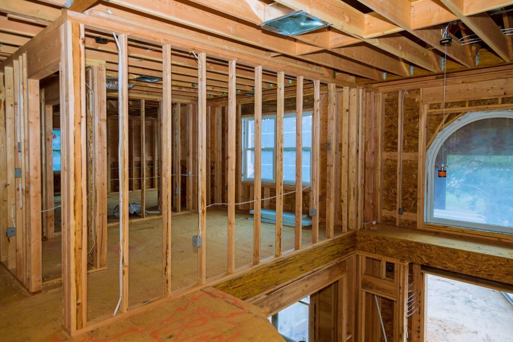 A room in a house that is being built with wooden beams.