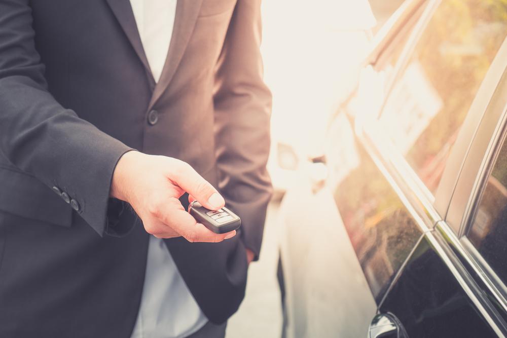 Man Unlocking Car Door with Remote — Lock Repairs in Home Hill, QLD