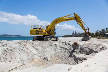Yellow Excavator on River Bank — A & B Mullins Excavations Pty Ltd in Bundaberg in Bundaberg , QLD