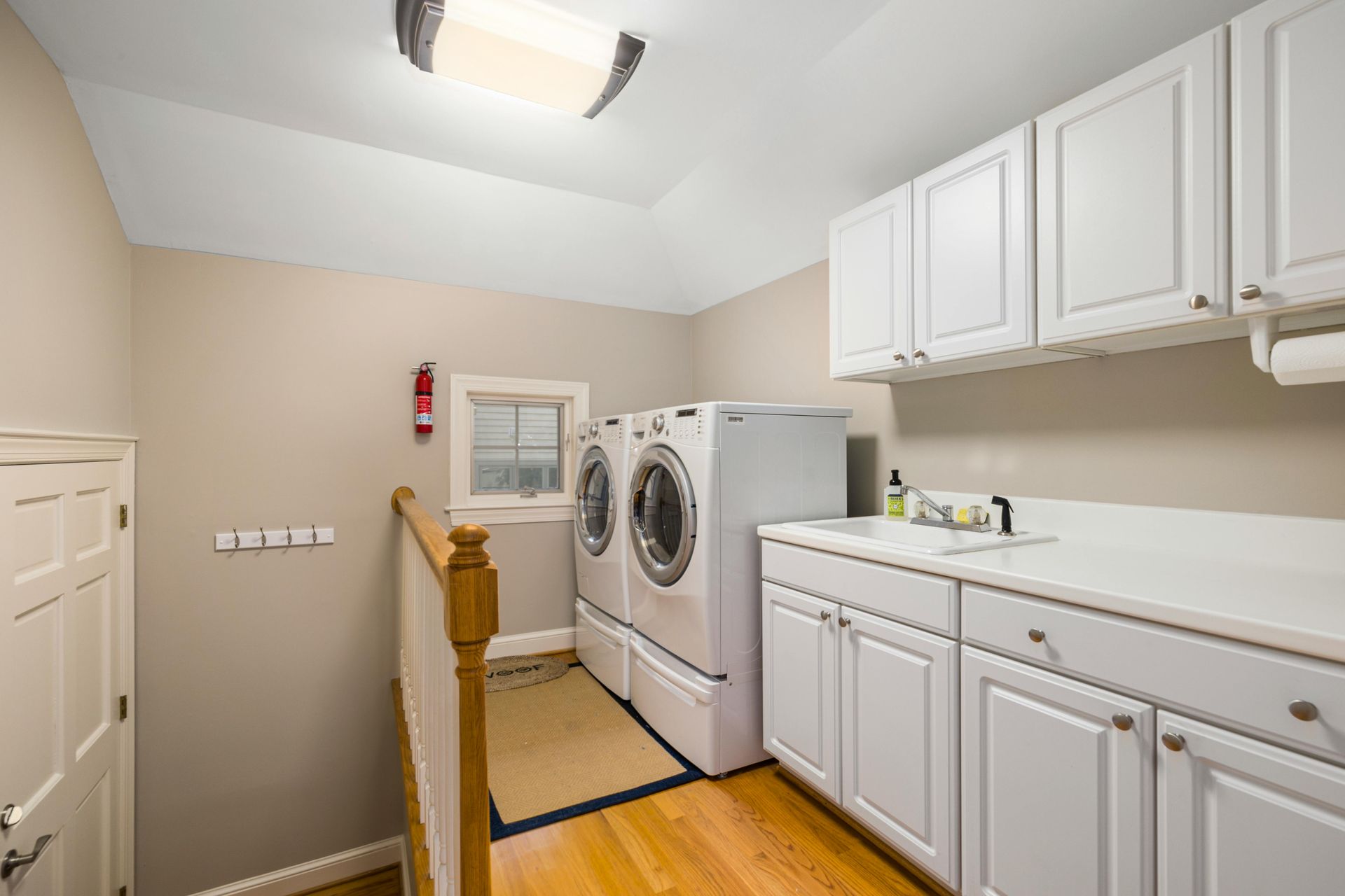 A laundry room with a washer and dryer and a sink.