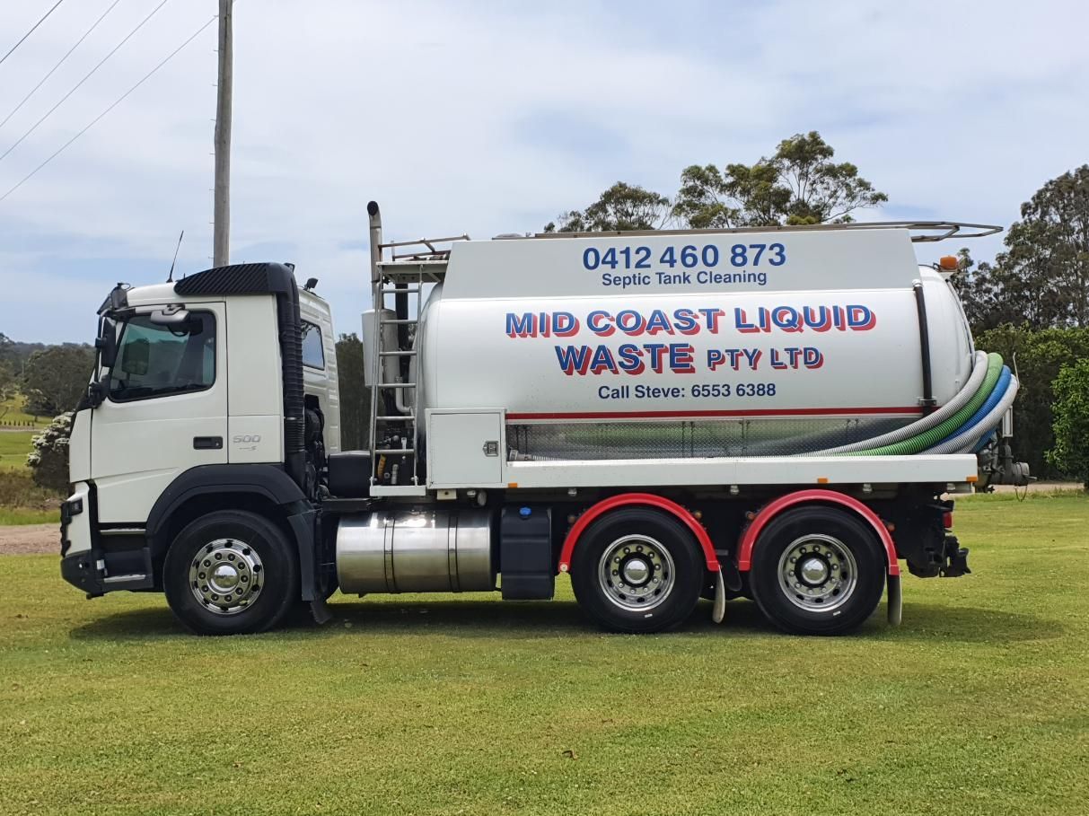 A Mid Coast Liquid Waste Truck is Parked in a Grassy Field — Mid Coast Liquid Waste In Nabiac, NSW