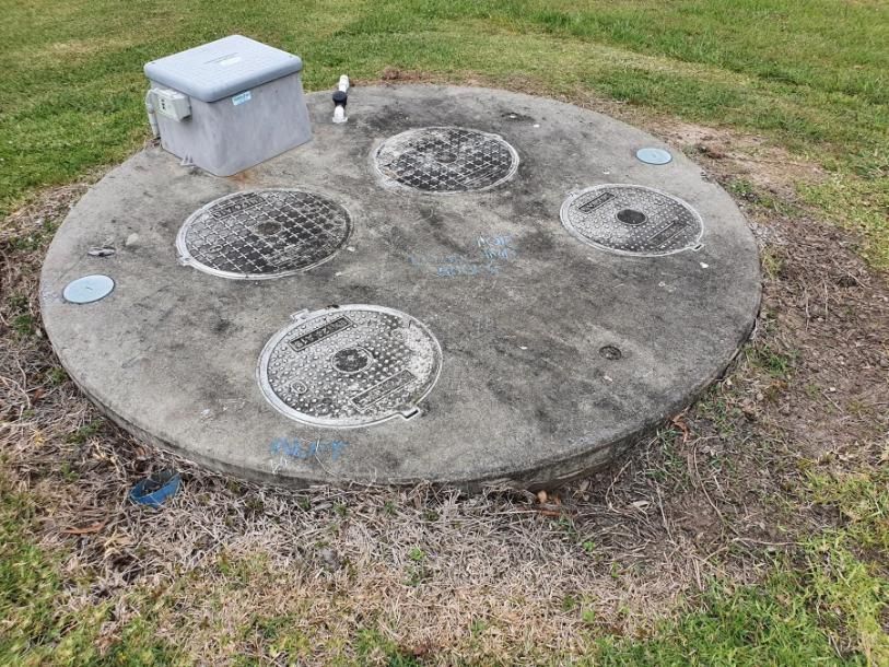 A Septic Tank is Sitting in the Middle of a Grassy Field — Mid Coast Liquid Waste In Rainbow Flat, NSW
