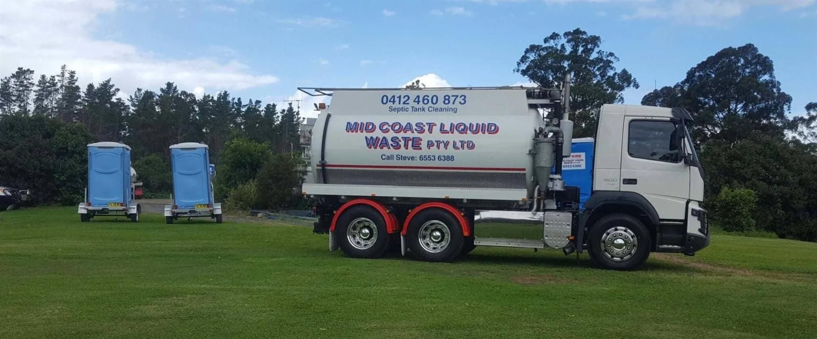 A White and Blue Truck is Parked in a Grassy Field — Mid Coast Liquid Waste In Rainbow Flat, NSW