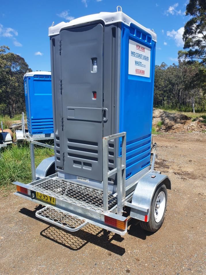 A Blue and Gray Portable Toilet is on a Trailer — Mid Coast Liquid Waste In Rainbow Flat, NSW