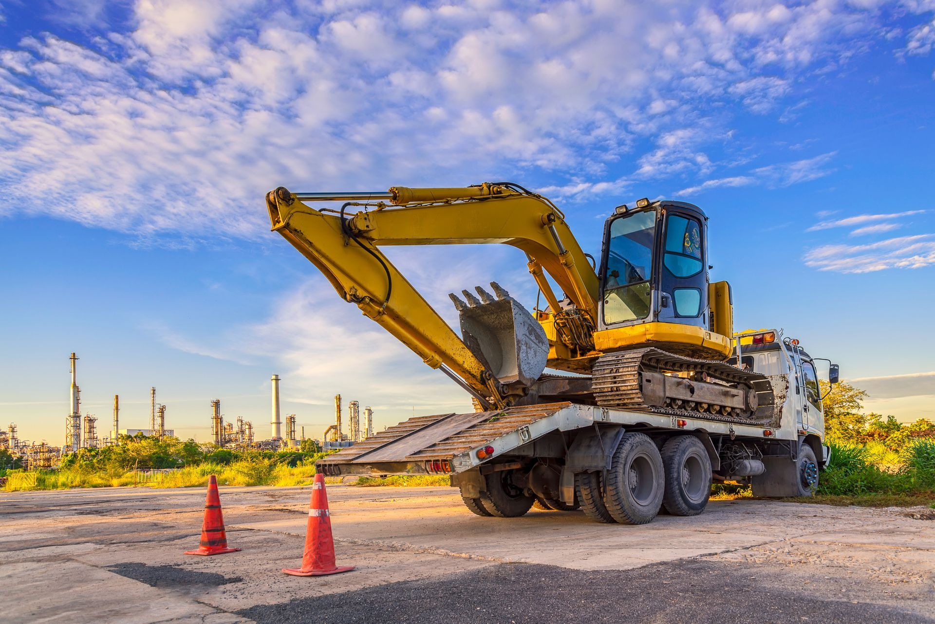 Excavator machine parked on a truck at a construction site.