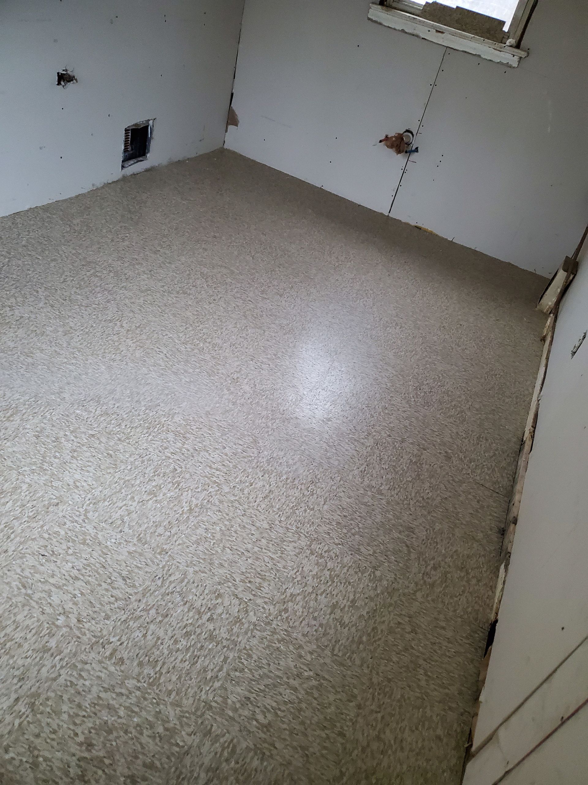 A room with a concrete floor and white walls.