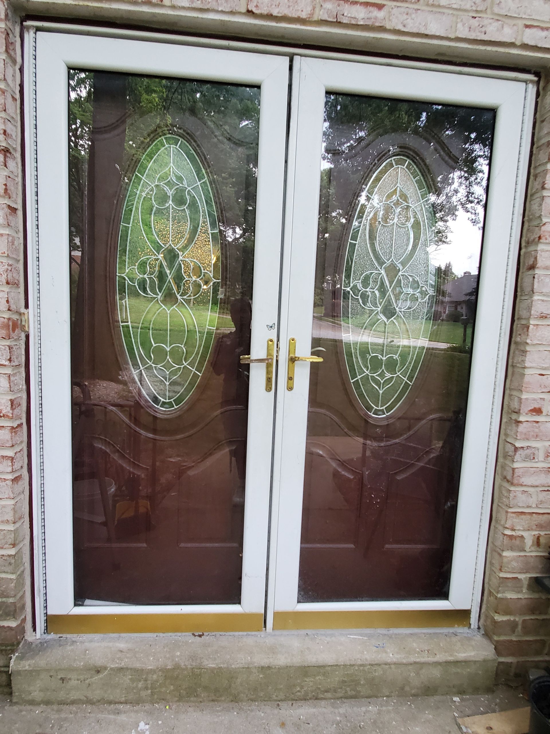A pair of stained glass doors on a brick building