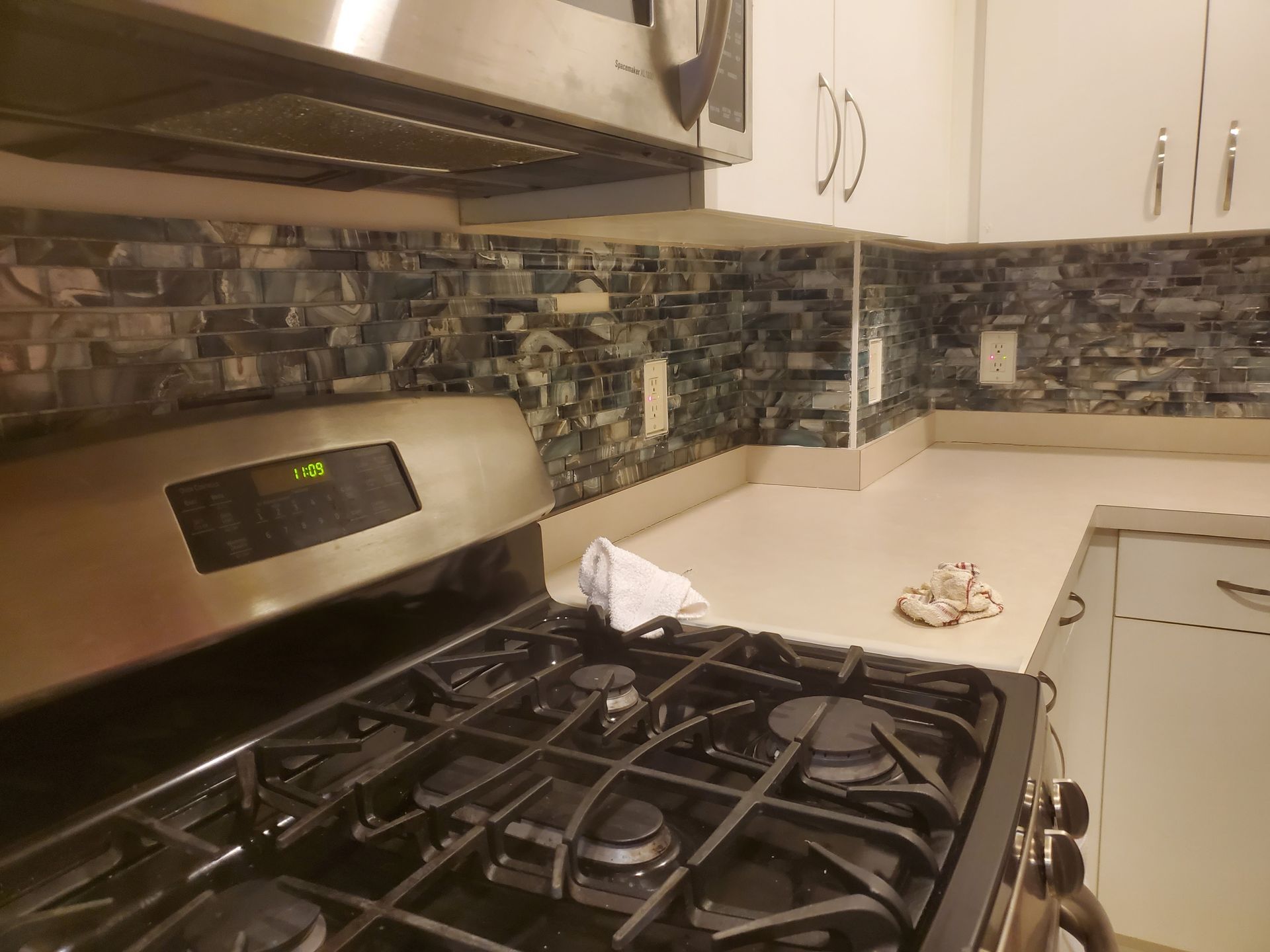 A kitchen with a stove top oven and a microwave.