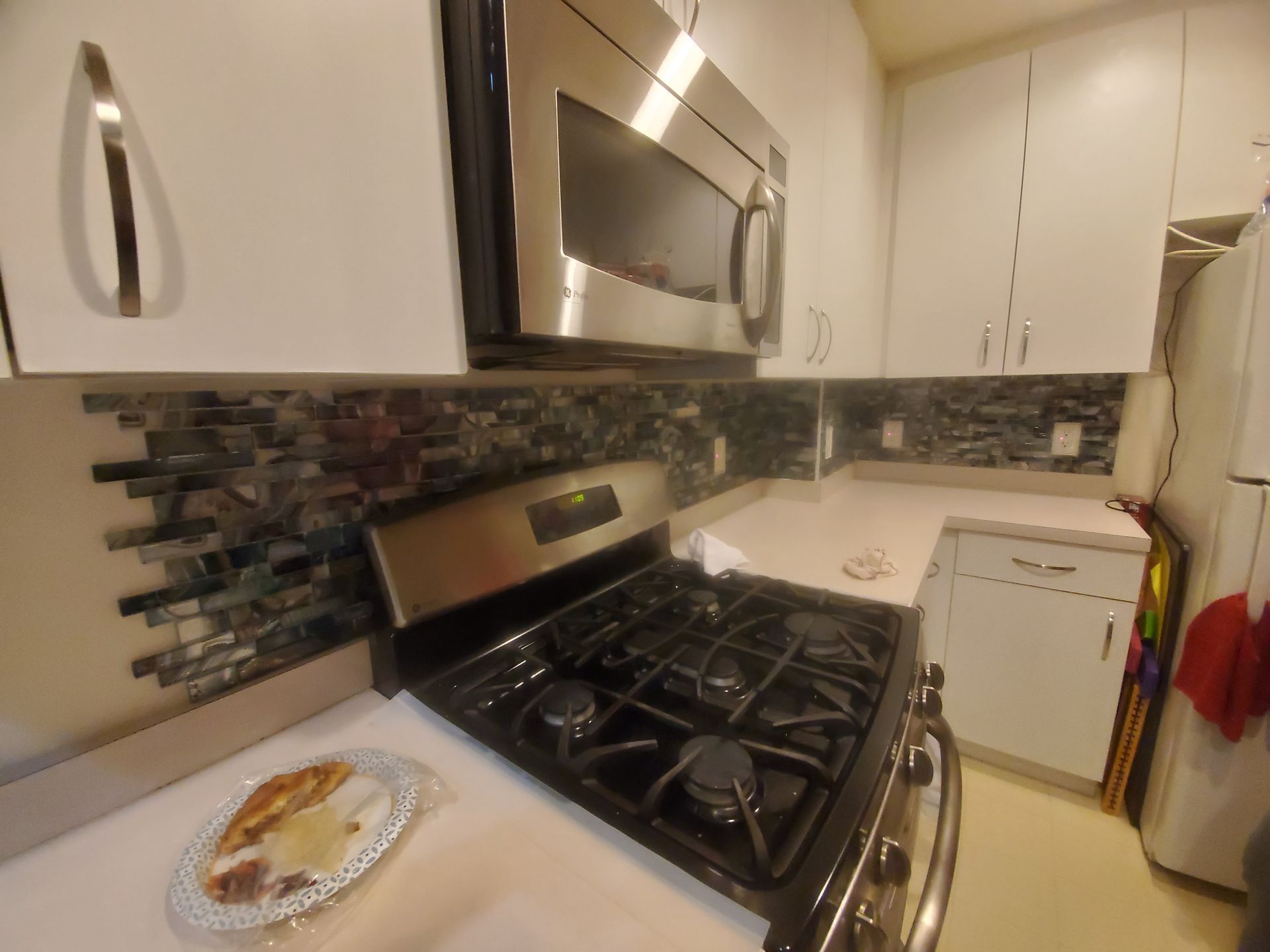 A kitchen with a stove top oven and a microwave