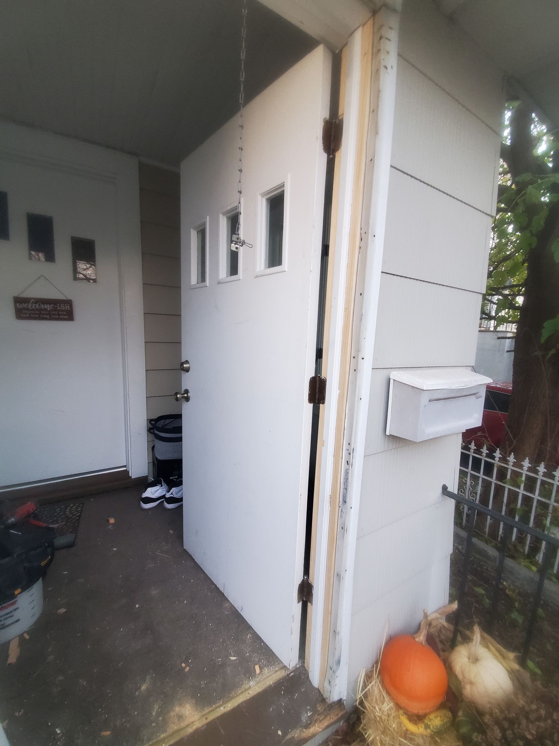 A white door with a mailbox on the side of it